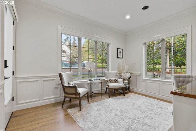 sitting room with crown molding, light hardwood / wood-style flooring, and plenty of natural light