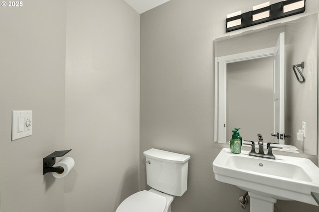 bathroom featuring toilet and a sink