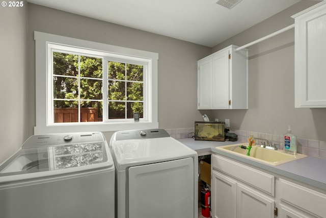 washroom featuring cabinet space and washing machine and dryer