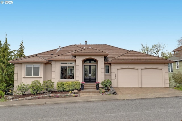 8333 NW Hazeltine St, Portland, OR 97229 - ranch-style house featuring french doors, a garage, stucco siding, a tile roof, and driveway