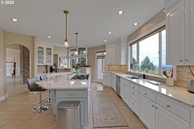 8333 NW Hazeltine St, Portland, OR 97229 - kitchen with a sink, white cabinetry, decorative backsplash, light tile patterned floors, and appliances with stainless steel finishes