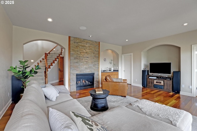 8333 NW Hazeltine St, Portland, OR 97229 - living area with wood finished floors, baseboards, a stone fireplace, recessed lighting, and arched walkways