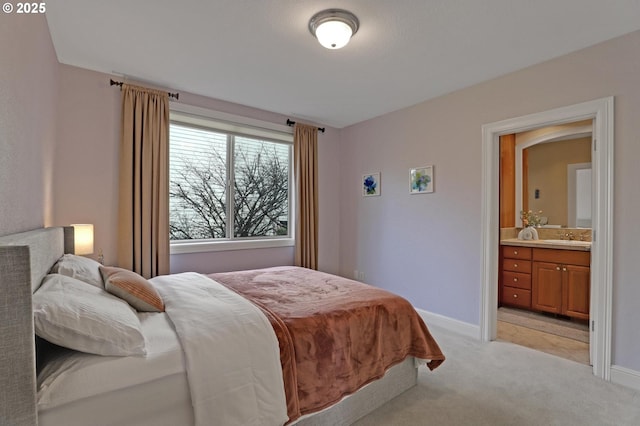 8333 NW Hazeltine St, Portland, OR 97229 - bedroom featuring a sink, light carpet, baseboards, and ensuite bath