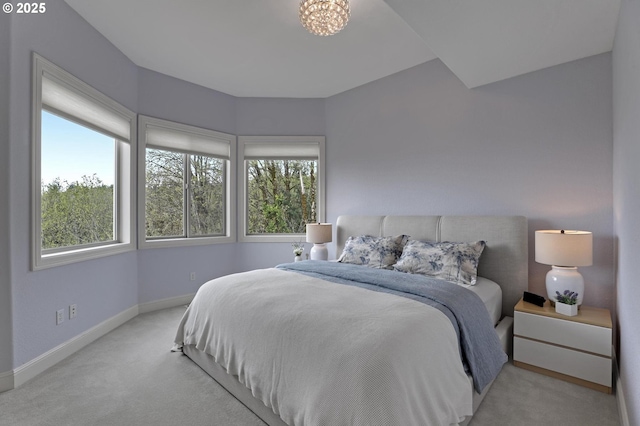 8333 NW Hazeltine St, Portland, OR 97229 - carpeted bedroom with multiple windows, baseboards, and a chandelier