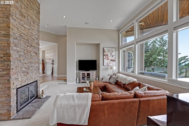 8333 NW Hazeltine St, Portland, OR 97229 - living room featuring a stone fireplace, crown molding, baseboards, recessed lighting, and carpet floors