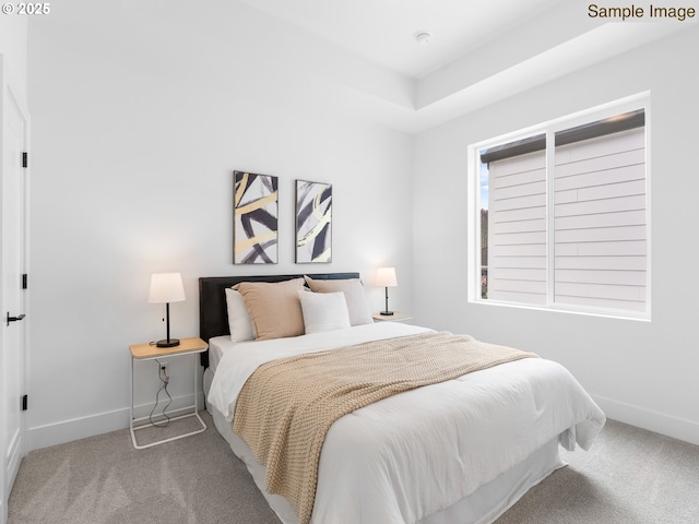 bedroom with baseboards and carpet flooring