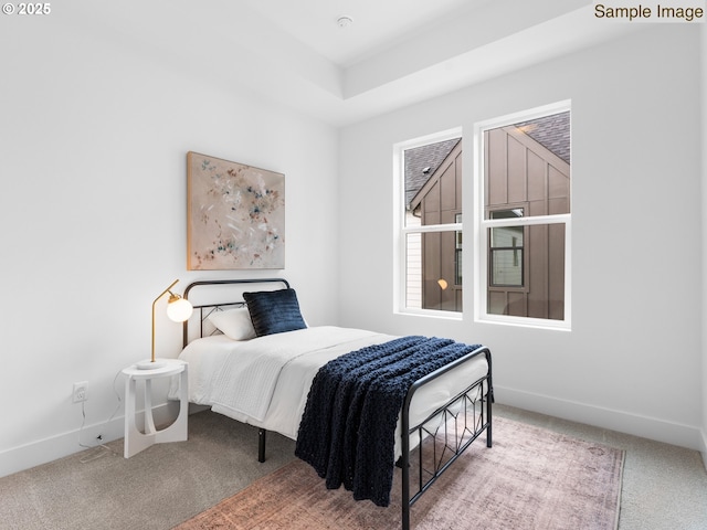 carpeted bedroom featuring baseboards