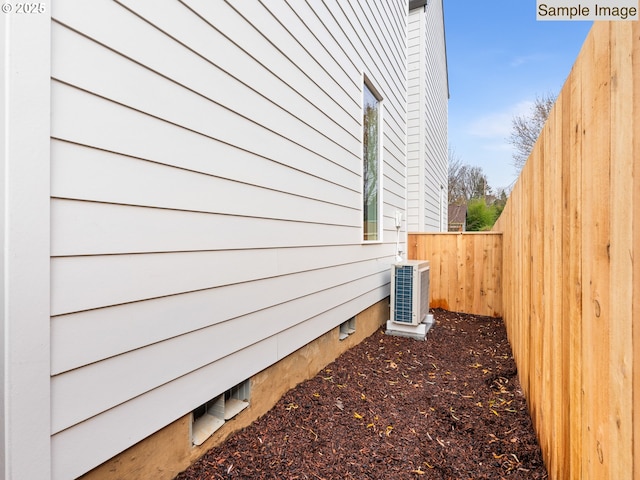 view of home's exterior with cooling unit and fence