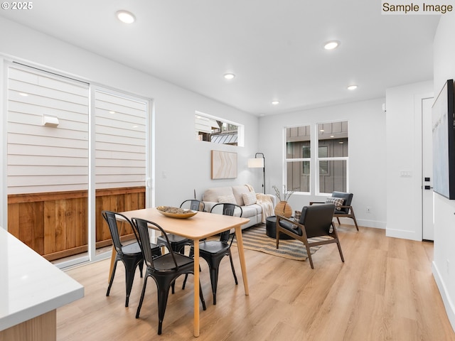 dining room featuring recessed lighting, light wood-type flooring, and baseboards