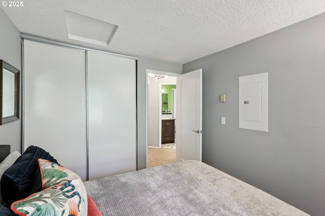 7915 SW Fanno Creek Dr Unit 1, Portland, OR 97224 - bedroom with electric panel, a closet, carpet floors, a textured ceiling, and attic access