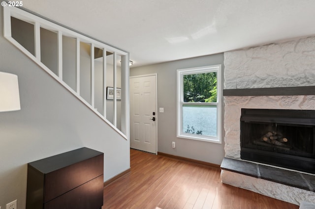 7915 SW Fanno Creek Dr Unit 1, Portland, OR 97224 - foyer featuring wood finished floors, baseboards, stairway, and a stone fireplace