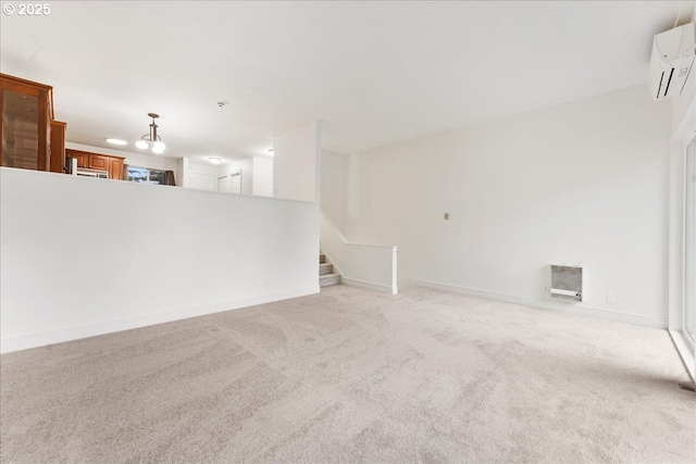 unfurnished living room featuring an AC wall unit and light colored carpet