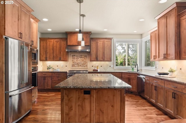 kitchen with backsplash, wood finished floors, stainless steel appliances, and recessed lighting