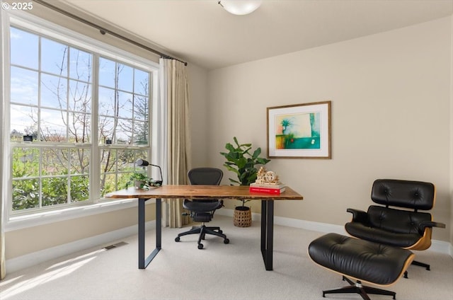 carpeted home office with baseboards and visible vents