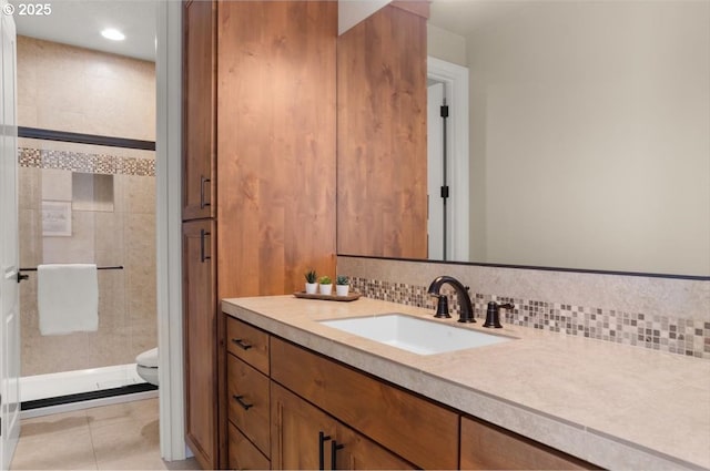full bathroom featuring a shower stall, tile patterned flooring, backsplash, toilet, and vanity