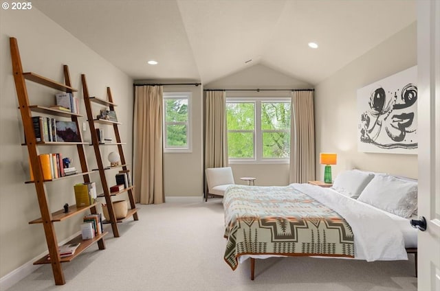 carpeted bedroom with vaulted ceiling and baseboards