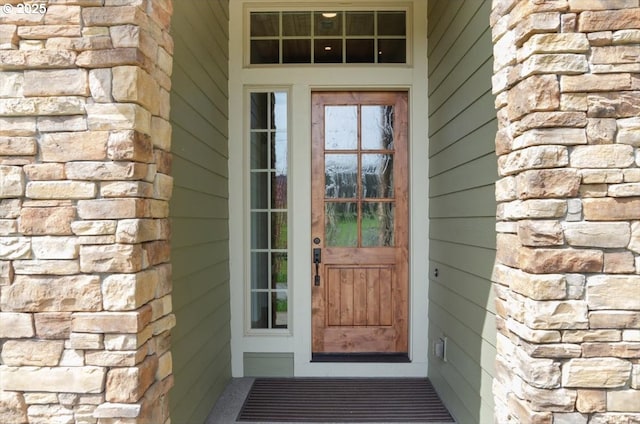property entrance with stone siding