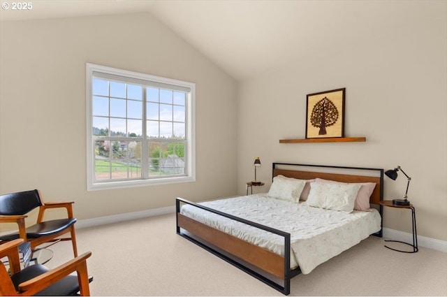 carpeted bedroom featuring lofted ceiling and baseboards