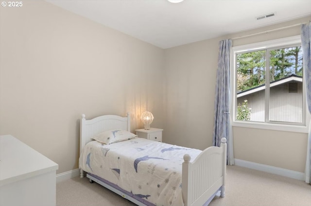 carpeted bedroom featuring baseboards and visible vents