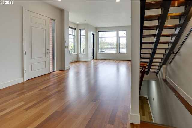1716 NW Riverscape St, Portland, OR 97209 - foyer with wood finished floors, baseboards, stairway, and recessed lighting