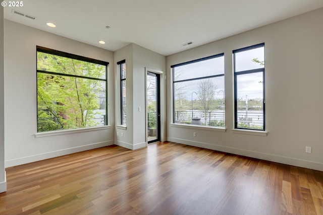 1716 NW Riverscape St, Portland, OR 97209 - empty room with baseboards, visible vents, and plenty of natural light