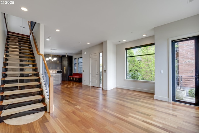 1716 NW Riverscape St, Portland, OR 97209 - foyer with recessed lighting, stairs, light wood-style floors, and baseboards