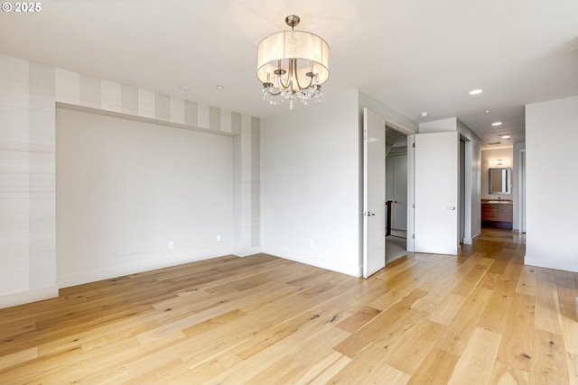1716 NW Riverscape St, Portland, OR 97209 - unfurnished dining area with recessed lighting, a notable chandelier, light wood-type flooring, and baseboards