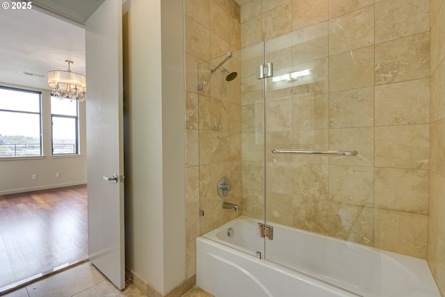 1716 NW Riverscape St, Portland, OR 97209 - bathroom with bathtub / shower combination, a notable chandelier, baseboards, and visible vents
