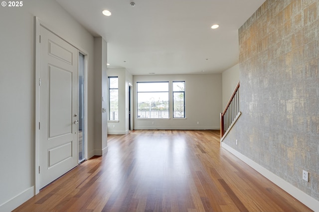 1716 NW Riverscape St, Portland, OR 97209 - foyer entrance with wood finished floors, recessed lighting, baseboards, and stairs
