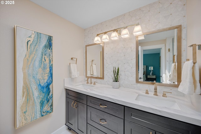 ensuite bathroom featuring double vanity, a sink, and ensuite bath