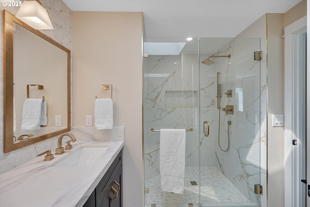 full bathroom with vanity, recessed lighting, and a marble finish shower