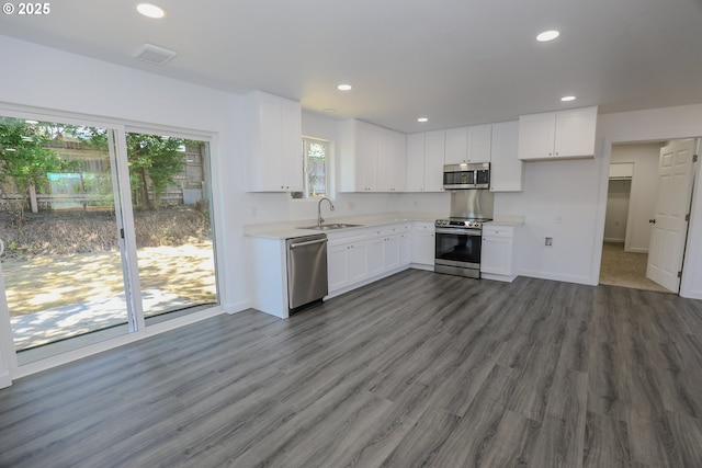 180 SE Darrell Ave, Winston, OR 97496 - kitchen with appliances with stainless steel finishes, light countertops, white cabinets, dark wood-type flooring, and recessed lighting