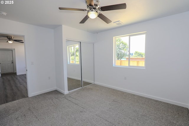 180 SE Darrell Ave, Winston, OR 97496 - unfurnished bedroom with multiple windows, carpet flooring, a closet, and a ceiling fan