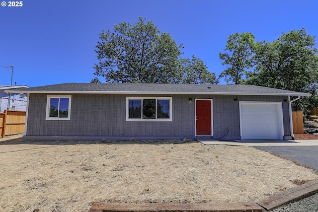 180 SE Darrell Ave, Winston, OR 97496 - ranch-style house with an attached garage and asphalt driveway