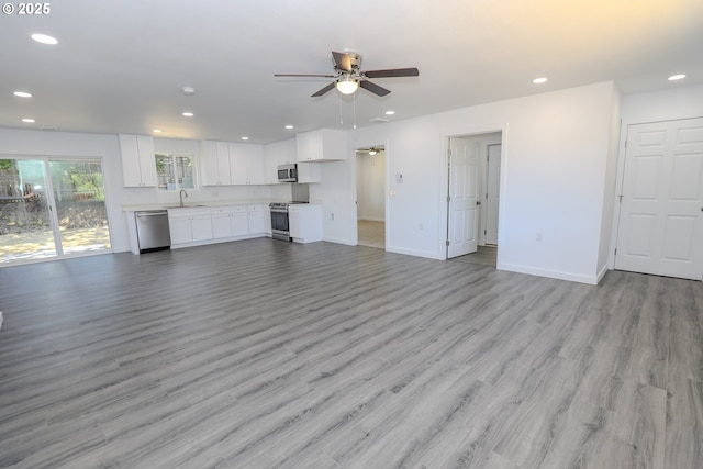180 SE Darrell Ave, Winston, OR 97496 - unfurnished living room featuring a ceiling fan, light wood-style floors, and recessed lighting