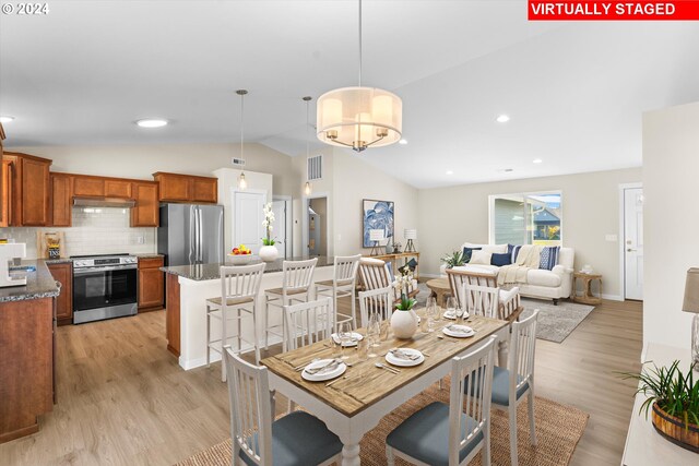 11480 Fern Way, Nehalem, OR 97131 - dining area with lofted ceiling, light wood-type flooring, baseboards, and recessed lighting