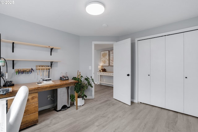 office space featuring baseboard heating and light wood-style flooring