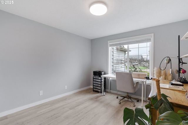 home office with baseboards and wood finished floors