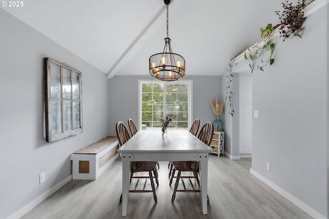 dining room featuring lofted ceiling, baseboards, a chandelier, and wood finished floors