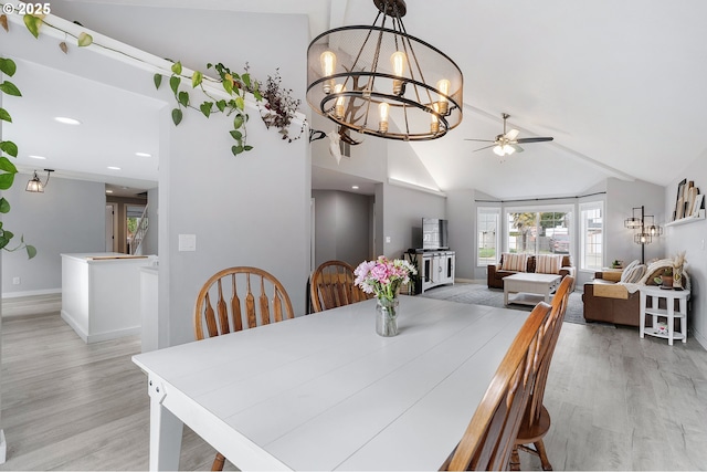 dining space featuring vaulted ceiling, recessed lighting, baseboards, and light wood-style floors