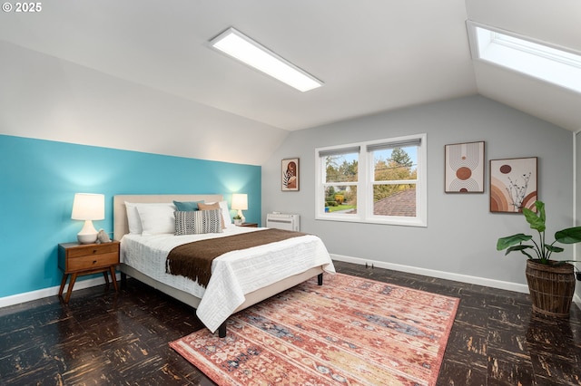 bedroom featuring baseboards and lofted ceiling with skylight