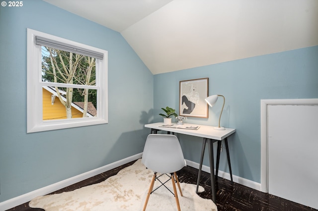 office with lofted ceiling, plenty of natural light, and baseboards