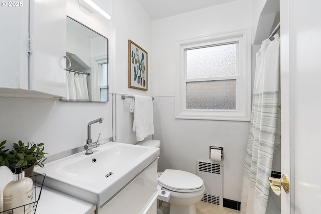 full bath featuring tile patterned flooring, radiator, vanity, and toilet