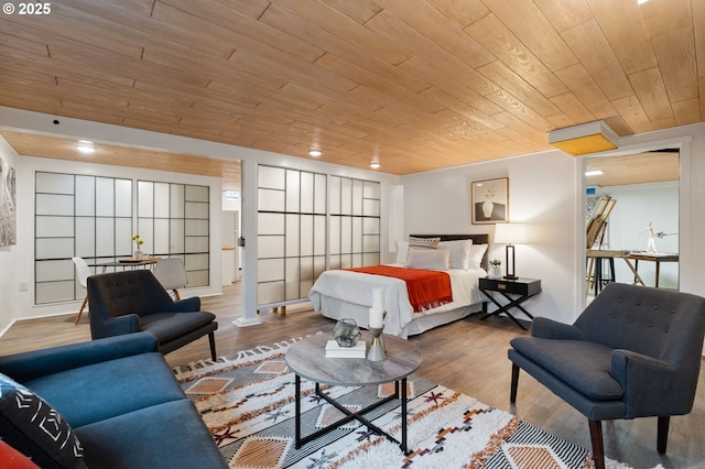 bedroom with wood ceiling and wood finished floors