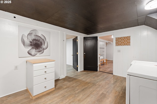 laundry area featuring laundry area, light wood-style floors, and washer and clothes dryer