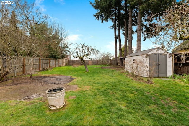 view of yard featuring a storage shed, a fenced backyard, and an outdoor structure