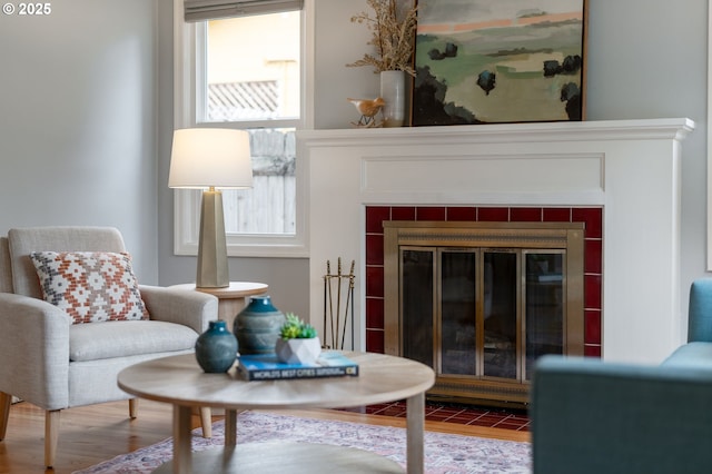 living area with a fireplace and wood finished floors