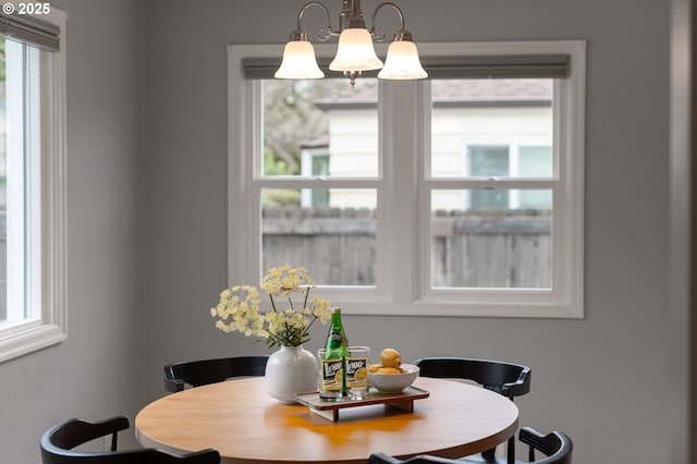 dining space with a wealth of natural light and a chandelier