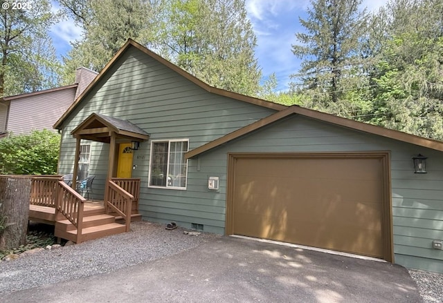 65121 E Lupine Dr, Rhododendron, OR 97049 - view of front of house featuring asphalt driveway, a chimney, and an attached garage