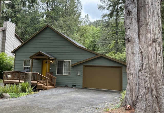 65121 E Lupine Dr, Rhododendron, OR 97049 - view of front facade featuring asphalt driveway, an attached garage, crawl space, and a wooden deck